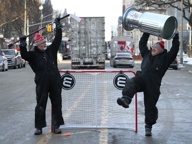 OTTAWA - Feb 1, 2022 - Anti vaccine mandate protesters and truckers protesting their fifth day in downtown Ottawa Tuesday. Al Fortin and Ron Rotxetter have a little fun celebrating their Unity Cup victory on Wellington Street Tuesday. The two guys from British Columbia has organized a road hockey hame for all who wants to join for 
Tuesday afternoon.