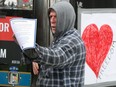 An unidentified man displays one of the warnings to protesters distributed by the Ottawa Police Service on Wednesday.
