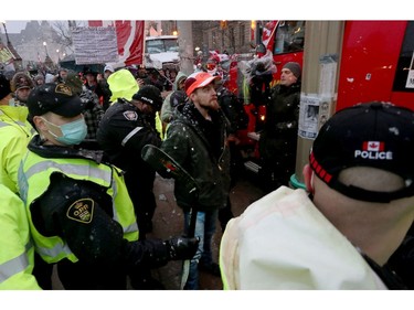 Truckers occupation and protesting continues its 21st day in downtown Ottawa Thursday. Police take a man (Red Hat) into custody near Parliament Hill Thursday evening.