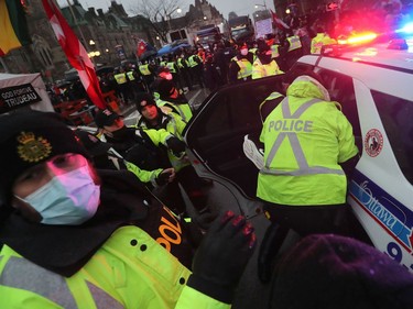 A protester involved in the so-called "Freedom Convoy" is arrested in downtown Ottawa on Feb. 17, 2022.
