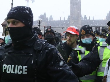 A protester involved in the so-called "Freedom Convoy" is arrested in downtown Ottawa on Feb. 17, 2022.