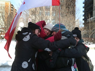 Truckers occupation and protesting continued its 23rd day in downtown Ottawa Saturday. Protesters and police clashed and people were arrested Saturday afternoon on Wellington Street. Friends give each other a hug good bye before leaving on Kent Street Saturday.