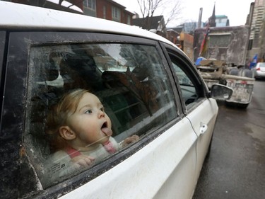 OTTAWA - Feb 2, 2022 - Anti vaccine mandate protesters and truckers protesting their sixth day in downtown Ottawa Wednesday. Tipopi Dulac (15 months) from Chertsey Quebec, licks the window as she plays in her car on Kent Street Wednesday. Tippi' and her parents are on day two of their protest.