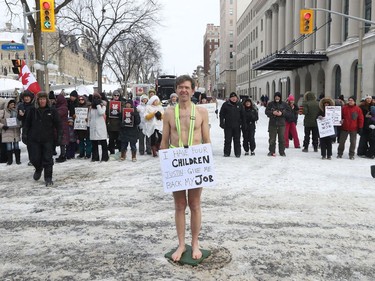 Anti-vaccine mandate protesters and truckers protesting their eighth day in Ottawa Friday. Liam, who is wearing a billboard was out protesting on Wellington Street asking for support to have the choice with his own body.