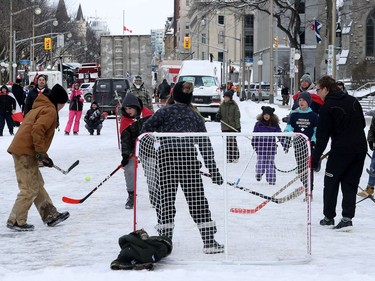 Anti-vaccine mandate protesters and truckers protesting their eighth day in Ottawa Friday.  A hockey game on Wellington Street.