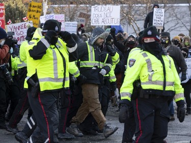 OTTAWA -- Counter protestors of the anti vaccine mandate protests continuing in downtown Ottawa. Ottawa police remove a ant mandate protester from amongst the counter protest crowd. Saturday, Feb. 5, 2022.