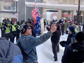 Screen grabs from video of protesters confronted by police near the Rideau Centre.