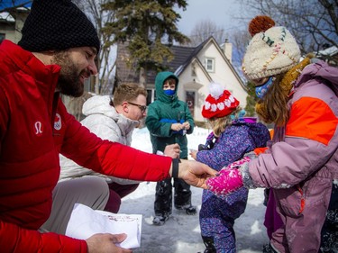 Team Canada bobsled members Mike Evelyn (left) and Cody Sorensen returned to Sorensen's family home in Hampton Park to greet some local kids who created a snow bobsled.