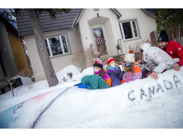Team Canada bobsleigh members Mike Evelyn, right, and Cody Sorensen returned to Sorensen's family home in Hampton Park to greet some local kids who created a snow bobsled.