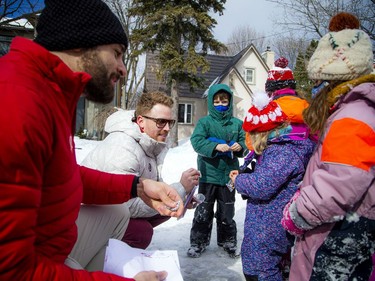 Team Canada bobsled members Mike Evelyn (left) and Cody Sorensen returned to Sorensen's family home in Hampton Park to greet some local kids who created a snow bobsled.