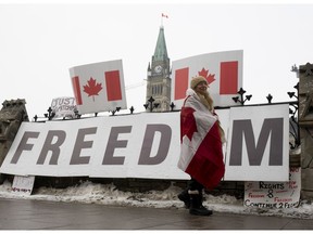 A protester walks along the sidewalk in front of the Parliament buildings on Feb. 8. Freedom! they cry, when what they really mean is licence to do as they please without regard for the rest.