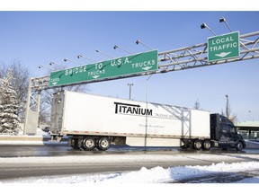 Truck traffic flows towards the Ambassador Bridge in Windsor on Feb. 14, after protesters who had blocked the major border crossing were removed by police.