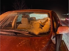 A woman was travelling eastbound on Highway 148 Monday night when a plate of ice from a truck travelling in the opposite direction crashed through her car's windshield, police said.