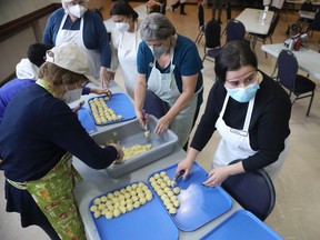 R to L: Dasha Velichko, Lisa Hrynuik and Sally Tchorewski prepare perogies at the Ukrainian Orthodox Cathedral in Ottawa, March 25, 2022. It's part of a fundraiser to support efforts by and for the Ukrainian community.