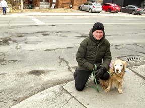 Dan Marks and Fanny at the corner of Bronson and Powell avenues. In the first 24 days of March, the city received 22 calls from residents complaining about the potholes at this intersection.