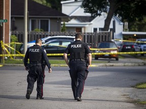 Ottawa Police Service officers investigate the scene of a stabbing death on Sept. 8, 2019.