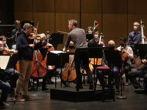 Alexander Shelley conducts the NAC Orchestra in rehearsal with violinist James Ehnes at Southam Hall on Tuesday.