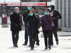 A group of individuals wearing masks walk on the University of Ottawa campus on Wednesday.