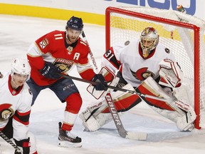 Jonathan Huberdeau (11) of the Florida Panthers waits for a tip-in attempt in front of goaltender Anton Forsberg (31) of the Ottawa Senators in the second period at FLA Live Arena on March 3, 2022 in Sunrise, Florida.