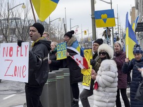 Protesters across the road from the United States Embassy on Sussex Drive on Tuesday evening shout demands for NATO to do more to help end the Russian invasion of Ukraine.