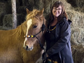 Trina Mather-Simard, founder and leader of Indigenous Experiences, at Màdahòkì Farm with Ojibwe Spirit Horse Kitagokons on Monday, Mar. 21, 2022.