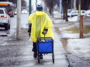 A shopper walks through the drizzle in Ottawa.