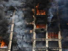 Flames erupt from an apartment building in the Ukraine capital Kyiv on March 15, 2022, as Russian strikes killed at least four people.