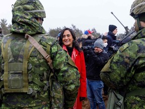 Minister of Defence Anita Anand talks with soldiers during a visit of the Adazi military base, near Riga, Latvia, on March 8, 2022.