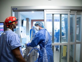 Medical staff intubate a COVID-19 patient in ICU