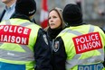 Tamara Lich speaks with police liaison officers before her arrest.