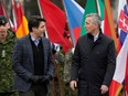 NATO Secretary-General Jens Stoltenberg and Canadian Prime Minister Justin Trudeau interact as they arrive in Adazi, Latvia on March 8, 2022.