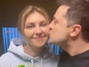 Ukraine's President Volodymyr Zelensky kisses his wife Olena Zelenska's cheek on Valentine's Day as they record a message in Kyiv, Ukraine February 14, 2022, in this screen grab obtained from a social media video recorded on February 14, 2022.