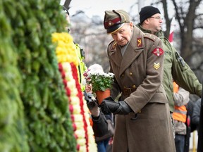 A veteran of the Latvian Legion, a force that was commanded by the German Nazi Waffen-SS during the Second World War, places flowers at the Monument of Freedom in Riga, Latvia on March 16, 2019. Some see the parade as glorifying Nazism because the Legion, founded in 1943, was commanded by Germany's Waffen-SS, the armed wing of the Nazi party's Schutzstaffel SS.