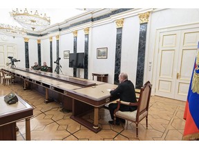 Russian President Vladimir Putin meets with Defence Minister Sergei Shoigu and chief of the general staff Valery Gerasimov in Moscow on Feb. 27.