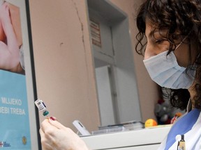 A health worker prepares vaccine.