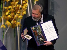 (FILES) In this file photo taken on December 10, 2021 Nobel Peace Prize laureate Dmitry Muratov of Russia poses with the Nobel Peace Prize diploma and medal during the gala award ceremony for the Nobel Peace prize in Oslo.