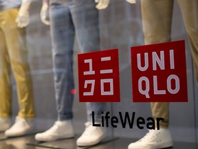 Clothing is displayed on mannequins in the store window of the Fast Retailing Co. Uniqlo Lee Theatre flagship store in Hong Kong, China, 2014.