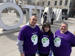 Haizel Reggler, middle, participates in Purple Day in Ottawa on Saturday with her parents Dave, left, and Sandi. Haizel, now 12, was diagnosed with epilepsy four years ago.
