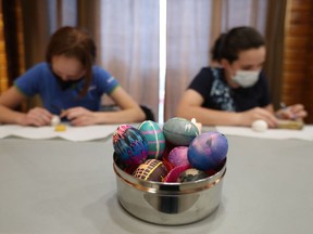 Girl Guides Mara Budge and her sister Charlotte paint Ukrainian Easter eggs  at the Lynwood Village Community Building in Ottawa earlier this week.