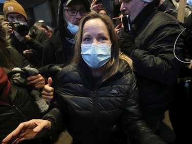 Convoy protest organizer Tamara Lich (wearing a mask) released on bail at the Ottawa Courthouse, Monday.