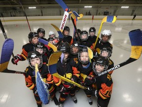 Players with the Ottawa West Golden Knights, a team of nine- and 10-year-olds, have put blue and yellow tape on their sticks in support of Ukraine.