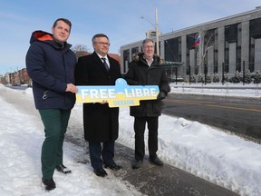 OTTAWA - March 2, 2022 - Mayor Jim Watson (R) is joined by Coun. Mathieu Fleury (L) and Andrii Bukvych, (C), Chargé D'Affaires at the Ukrainian Embassy in Canada, to unveil street signs, a symbol of support for the people of Ukraine.