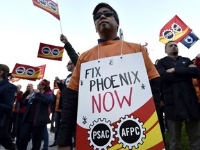 FILE PHOTO: Public servants protest over problems with the Phoenix pay system outside the Office of the Prime Minister and Privy Council in 2017.