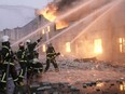Ukrainian firefighters extinguish a blaze at a warehouse after a bombing in Kyiv, Ukraine, Thursday, March 17.