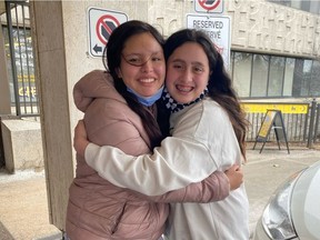 Serene Summers, left, hugs her best friend Eva Salinas, outside CHEO on Tuesday. Eva was with Serene when she was struck by a hit-and-run driver on Feb. 13.