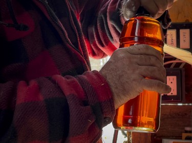 OTTAWA -- Since 1920 the Proulx family have operated their sugar bush in Cumberland. Francois Proulx bottles some fresh maple syrup on Wednesday, Mar. 16, 2022
