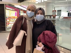 Carleton University students Huda Khan and Thana Taher at the Rideau Centre on the first day of discretionary masking in indoor public settings since July 2020.