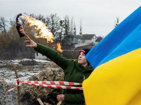 A Ukrainian civilian trains to throw Molotov cocktails as Russia's invasion of Ukraine continues, in Zhytomyr, Ukraine March 1.