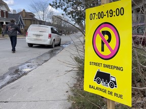 Street sweeping no parking signs on Huron Avenue on Monday, Apr. 4, 2022