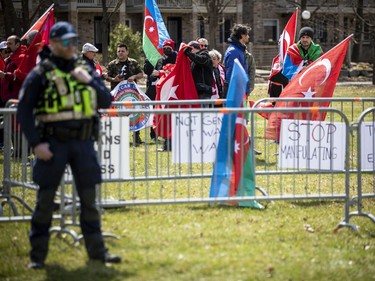 A small group of counter-protesters were on site Sunday, separated from the Armenian supporters by metal fences and police.